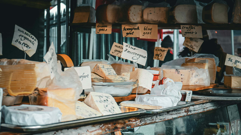 A seasonal sampling of cheeses on top of the fridge at Ashtons Fromagerie's.
